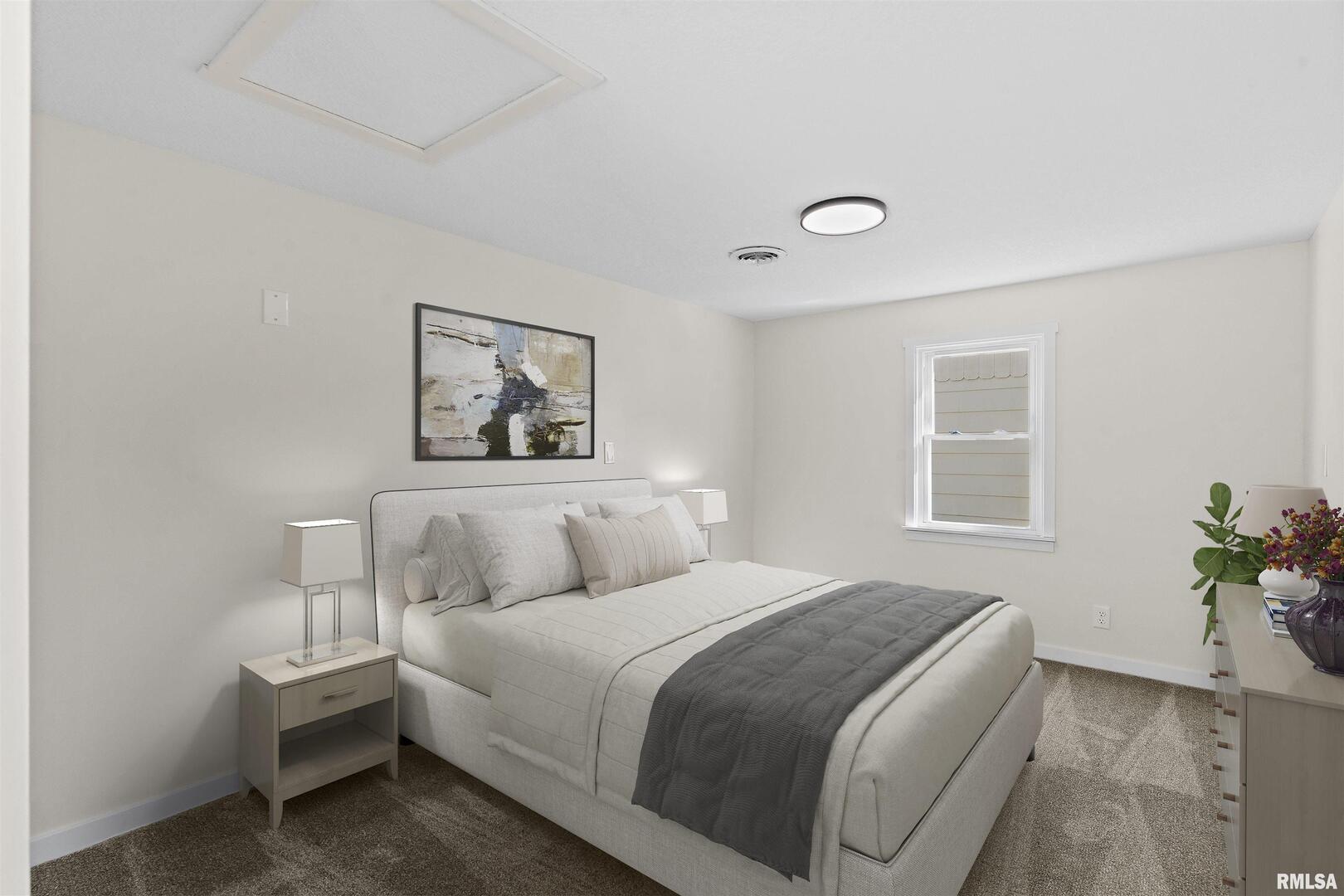 1501 43rd Street Moline, IL 61265 - Photo 13 of 27 a bedroom with a bed and a potted plant