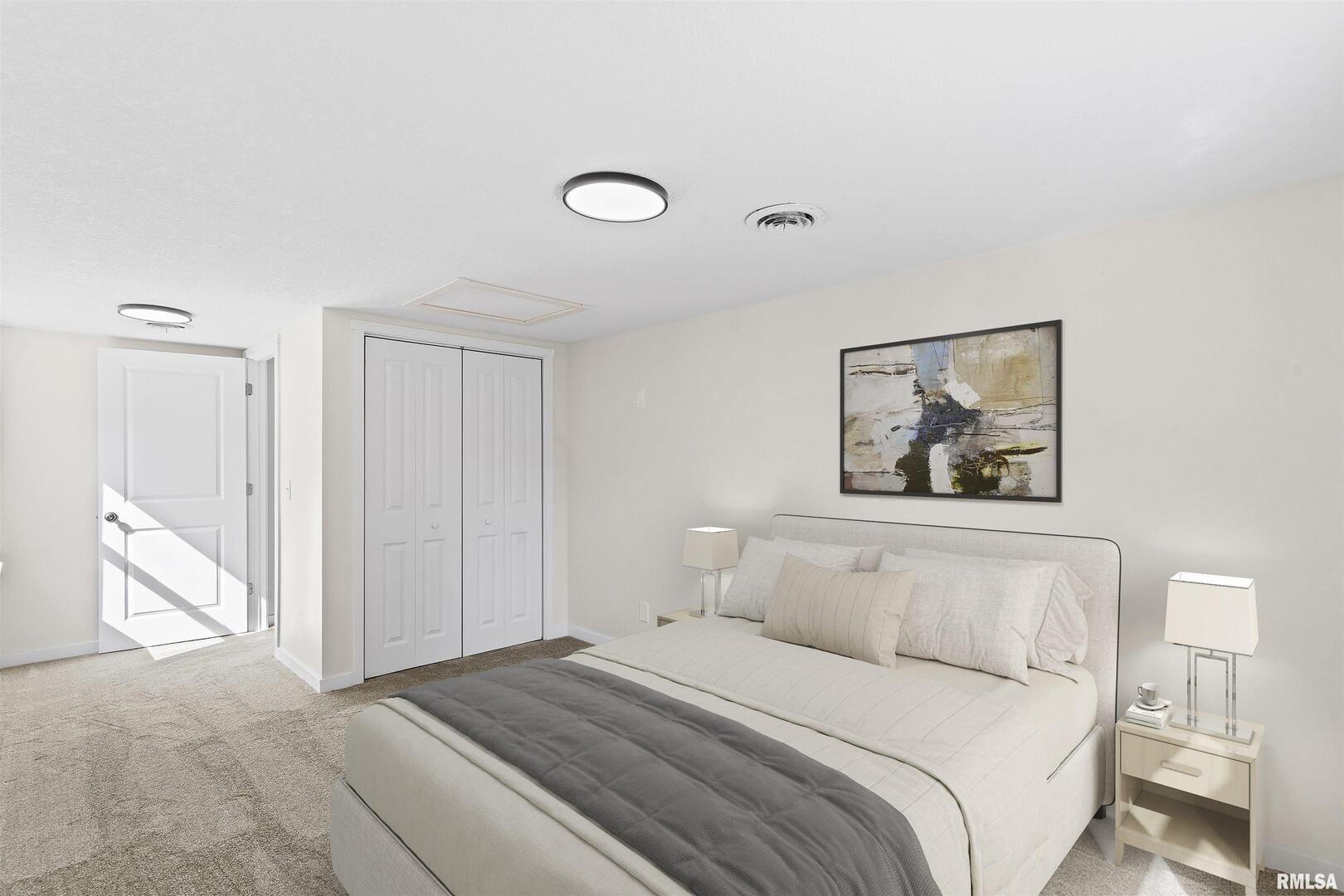 1501 43rd Street Moline, IL 61265 - Photo 14 of 27 a bedroom with a bed and a painting on the wall