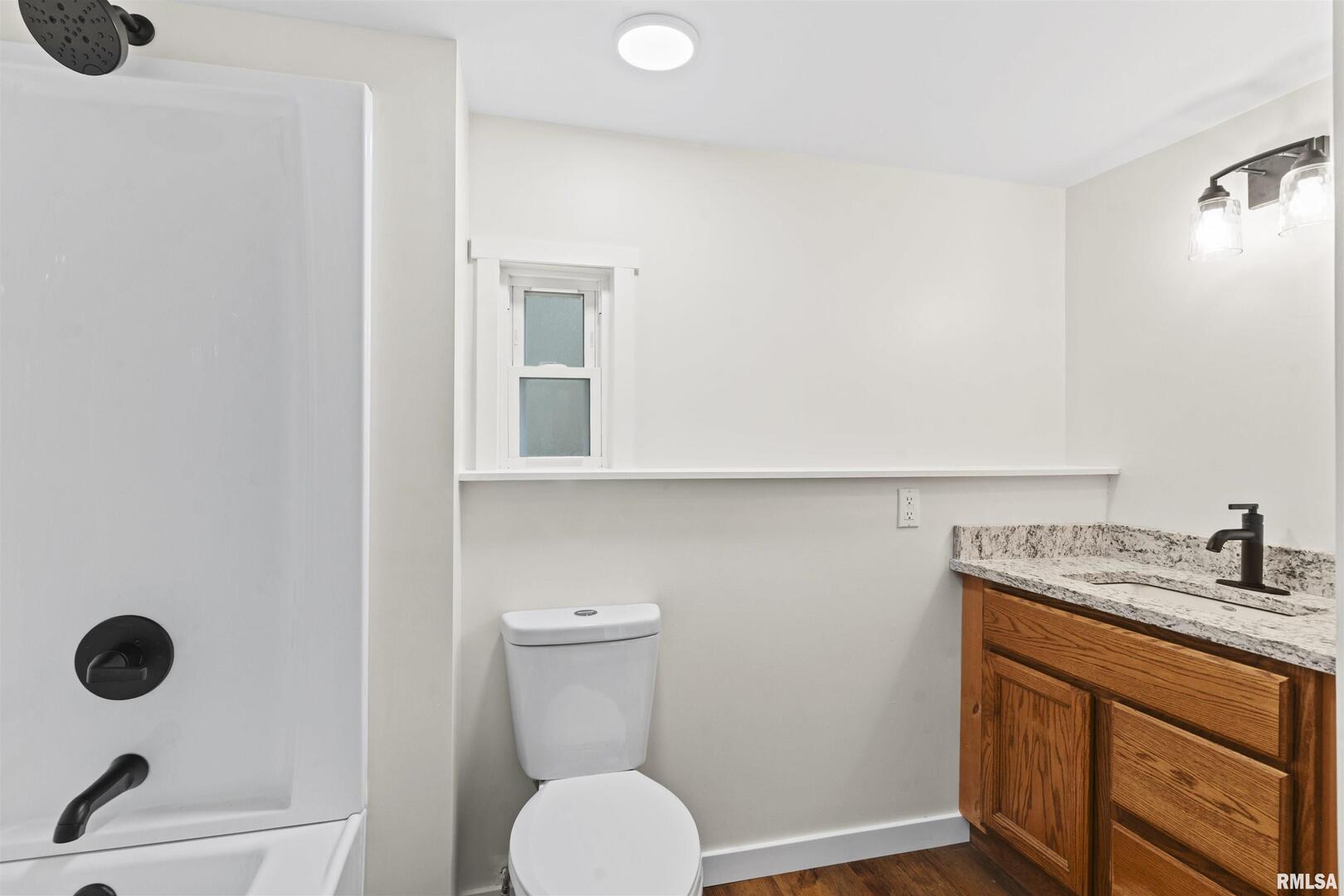 1501 43rd Street Moline, IL 61265 - Photo 15 of 27 a bathroom with a granite countertop sink and a mirror