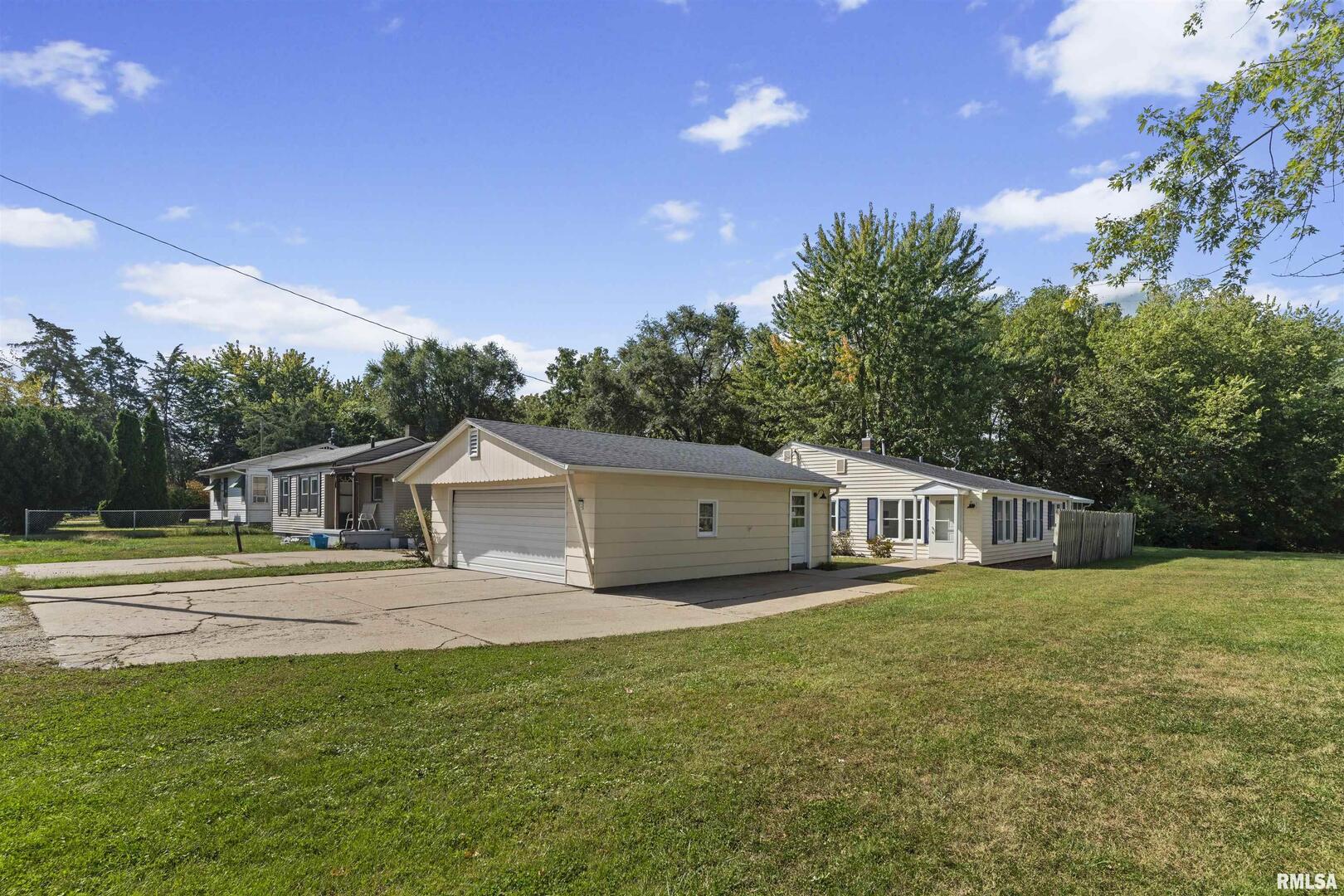 1501 43rd Street Moline, IL 61265 - Photo 2 of 27 a view of a house with a big yard and large trees