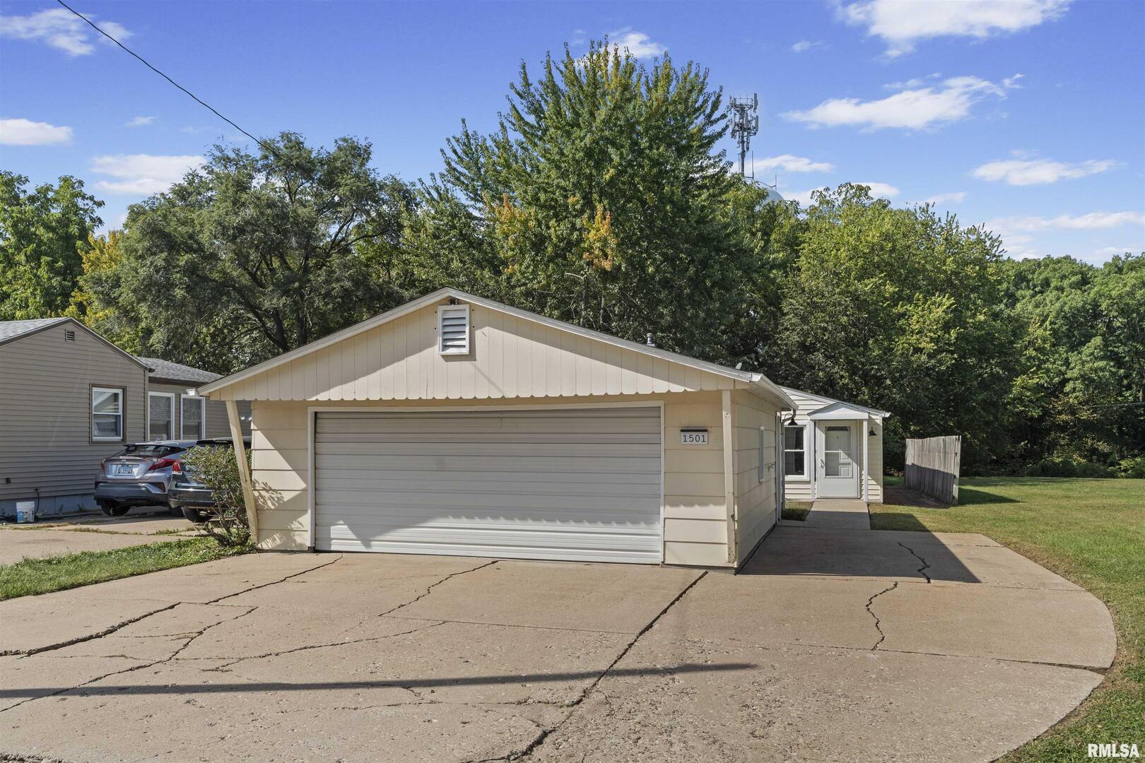 1501 43rd Street Moline, IL 61265 - Photo 3 of 27 a front view of a house with a yard and garage
