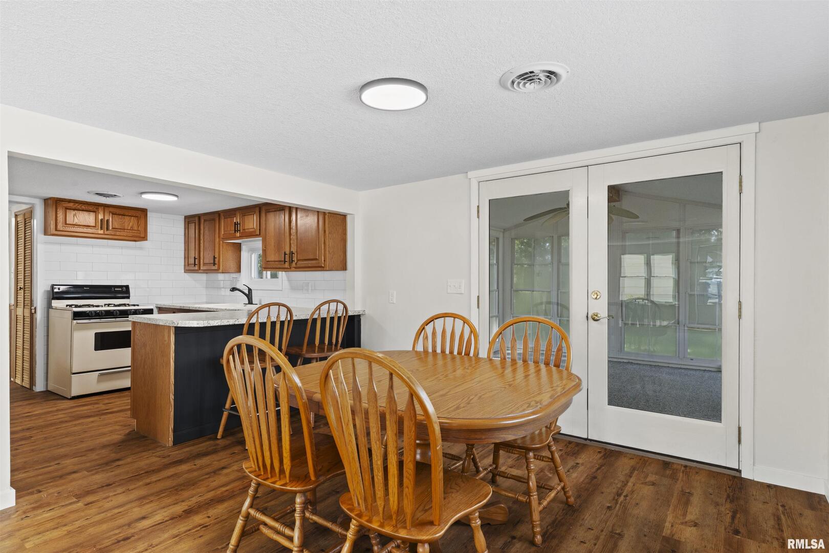 1501 43rd Street Moline, IL 61265 - Photo 6 of 27 a view of a dining room with furniture and wooden floor