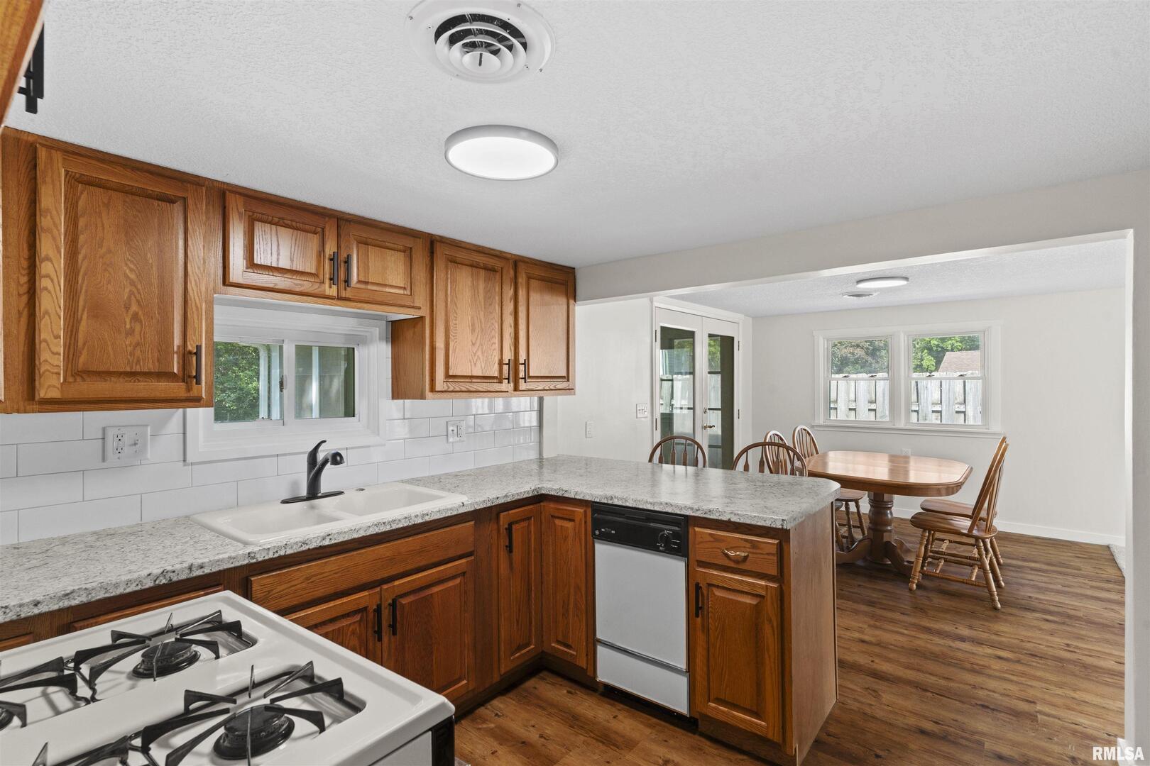 1501 43rd Street Moline, IL 61265 - Photo 9 of 27 a kitchen with a sink stove and wooden cabinets