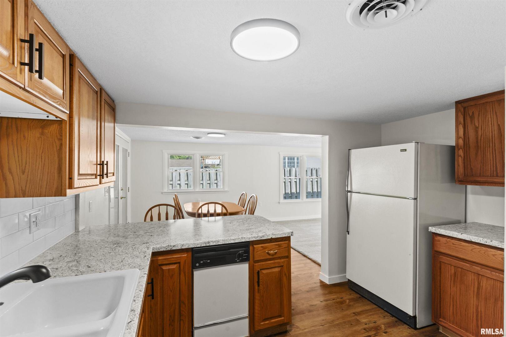 1501 43rd Street Moline, IL 61265 - Photo 10 of 27 a kitchen with stainless steel appliances granite countertop a refrigerator and a sink