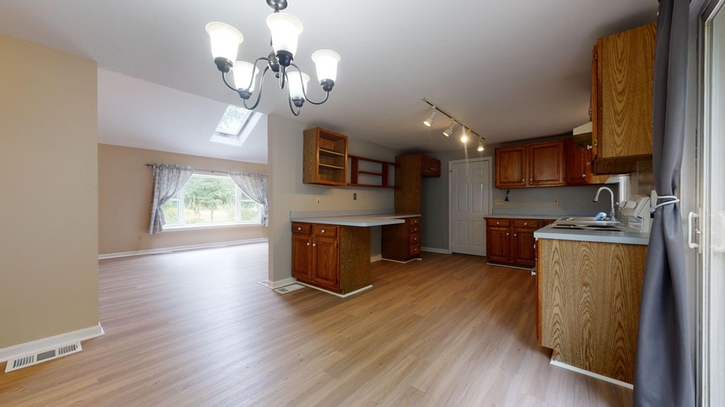 1 Friendly Road Forestdale, MA 02644 - Photo 14 of 38 a kitchen with stainless steel appliances granite countertop wooden floors a stove and a window