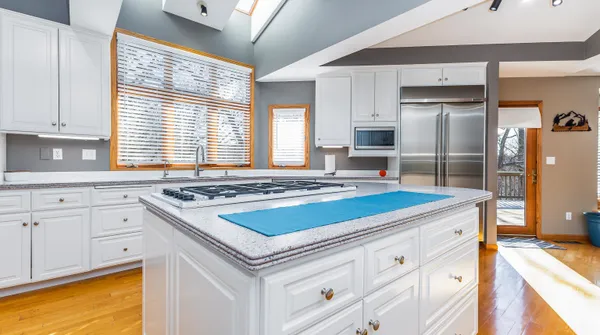 a bathroom with a sink a mirror and a potted plant