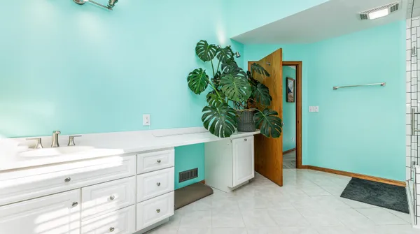 a room with wooden floor pool table and windows