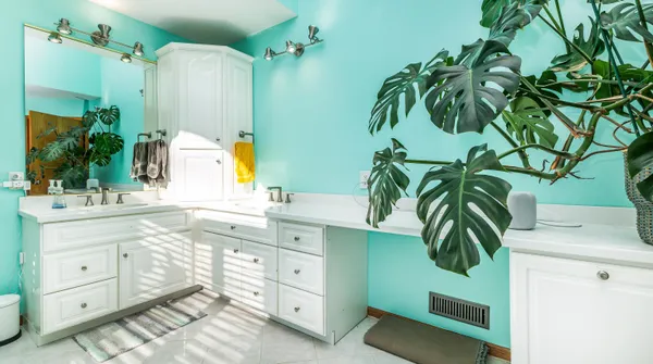 a room with wooden floor pool table and rug