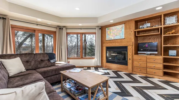 a living room with a flat screen tv and a toilet