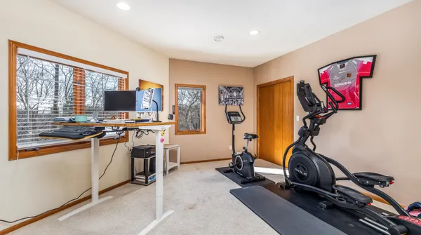 a bedroom with a large bed and wooden floor