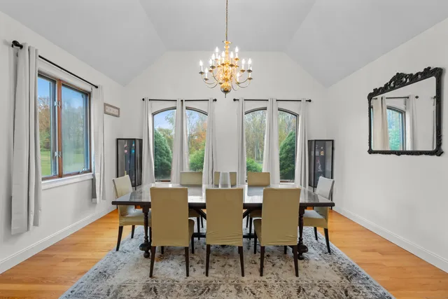 a view of a dining room with furniture wooden floor and chandelier