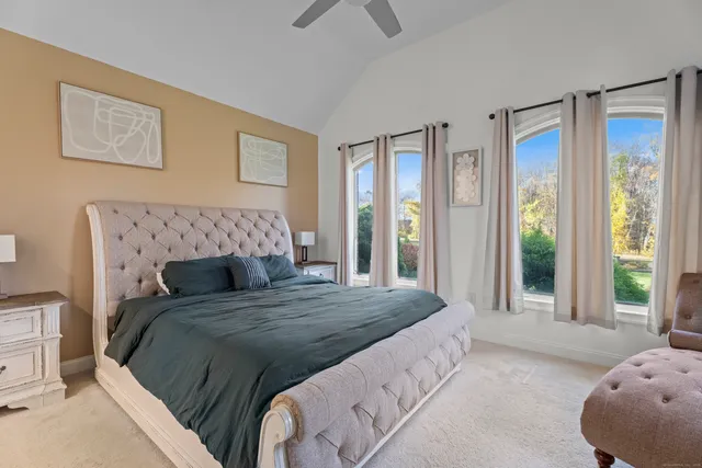 a bedroom with a large bed and a large window