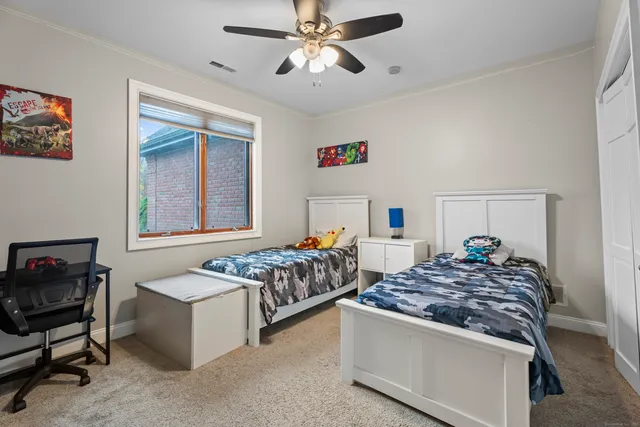 a bedroom with bed and window