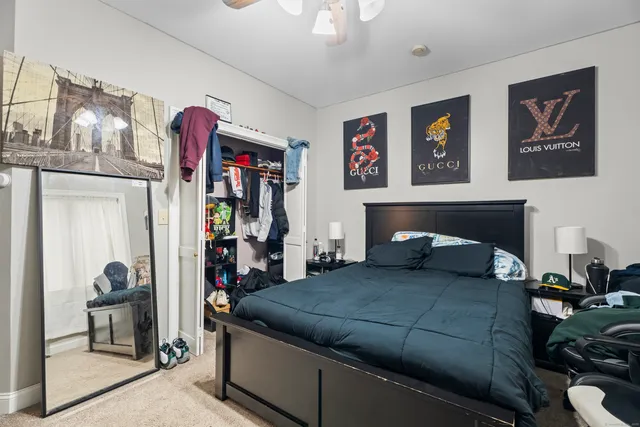 a bedroom with a bed and a mirror on dresser