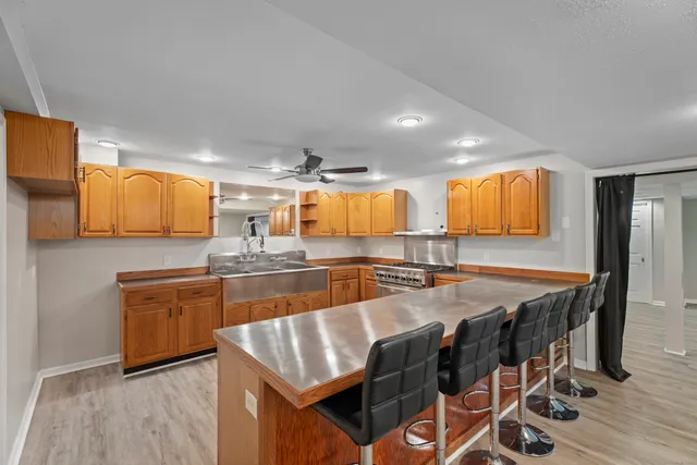 a large kitchen with granite countertop a large counter top space and stainless steel appliances