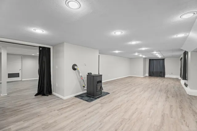 a empty room with wooden floor and windows