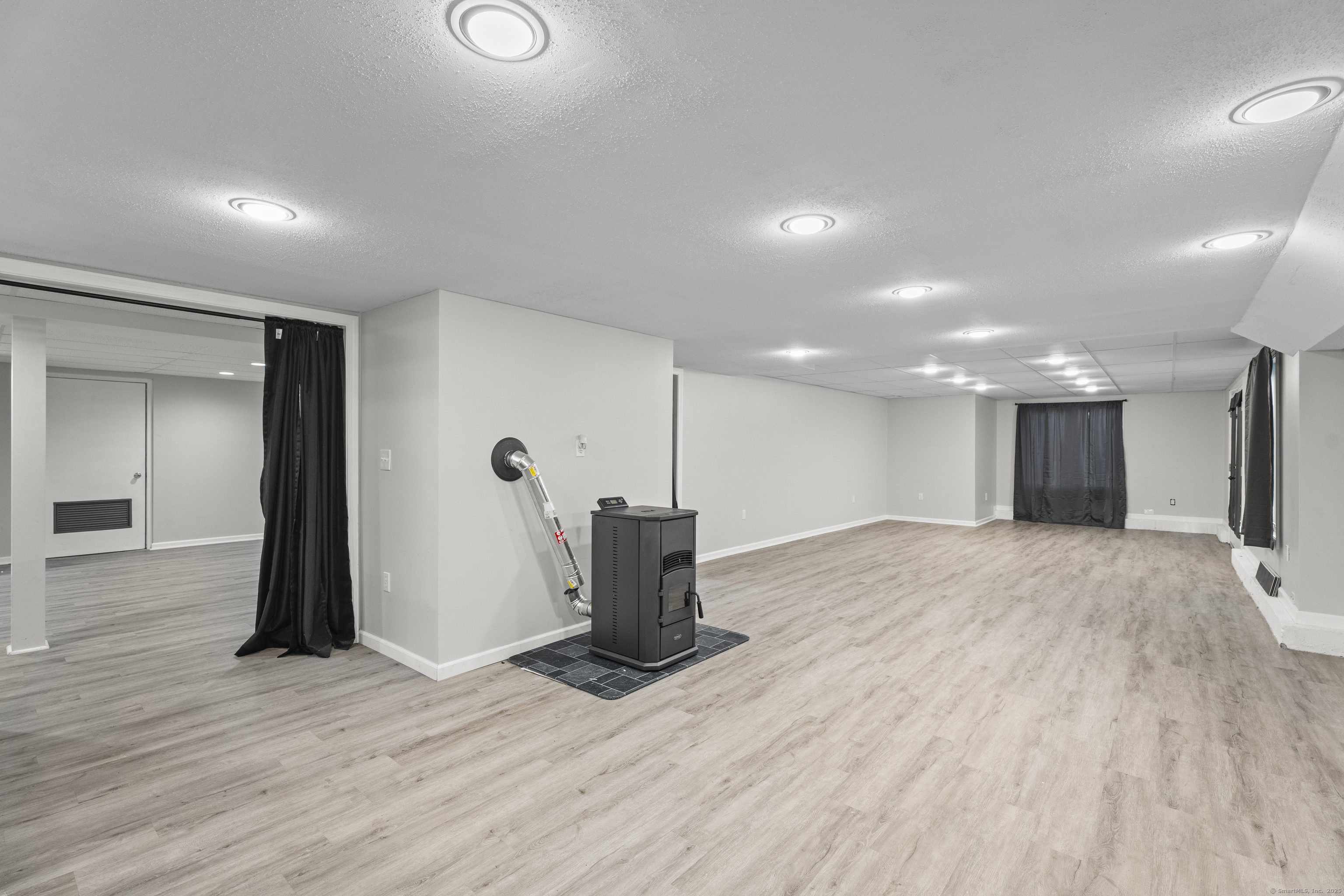 305 Killorin Road Watertown, CT 06795 - Photo 34 of 40 a empty room with wooden floor and windows