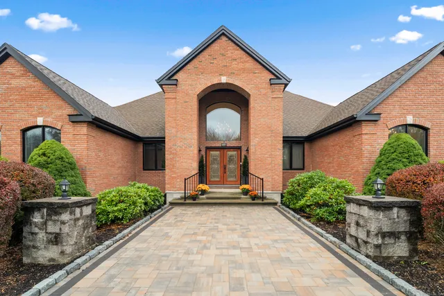 a view of a brick house with potted plants