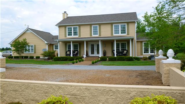 8476 Cedar Grove Road Cross Plains, TN 37049 - Photo 1 of 20 a front view of a house with a yard and trees