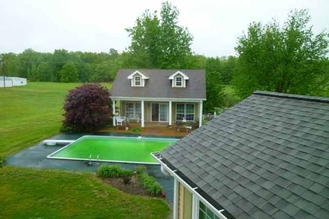 8476 Cedar Grove Road Cross Plains, TN 37049 - Photo 3 of 20 a view of a house with a yard potted plants and a table