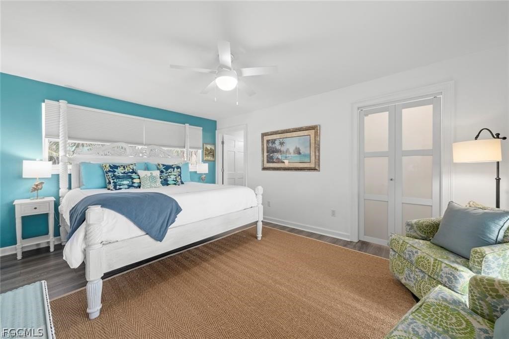 6093 Henderson Road Sanibel, FL 33957 - Photo 18 of 49 a bedroom with a bed lamp and a large window