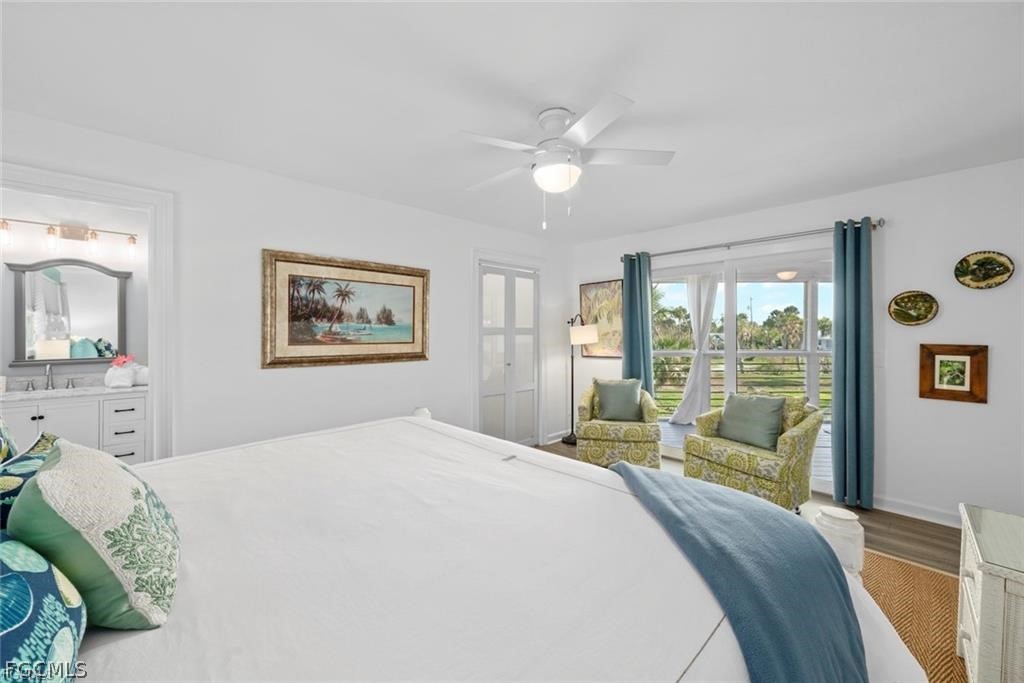 6093 Henderson Road Sanibel, FL 33957 - Photo 21 of 49 a bedroom with a bed and a large window with the outer view