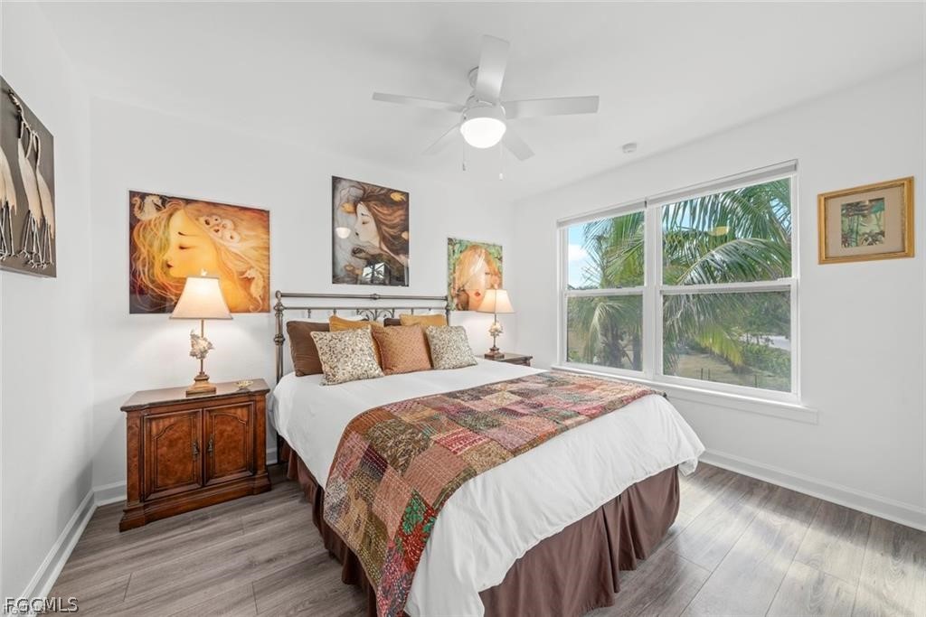 6093 Henderson Road Sanibel, FL 33957 - Photo 24 of 49 a bedroom with a bed and a window
