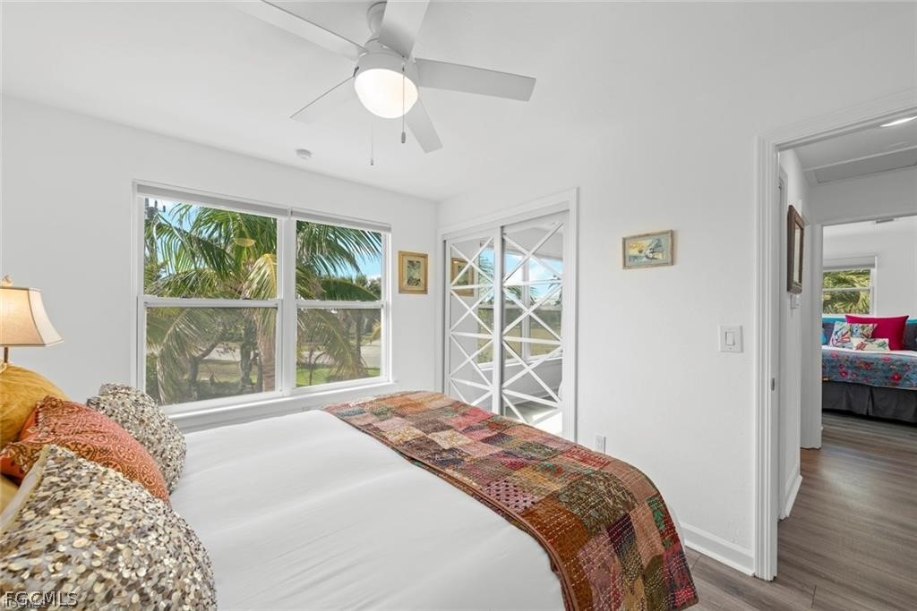6093 Henderson Road Sanibel, FL 33957 - Photo 26 of 49 a bedroom with a large bed and a window