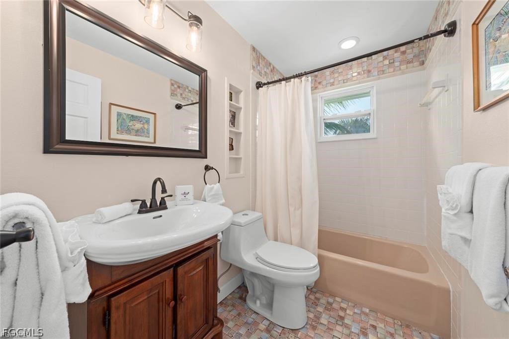 6093 Henderson Road Sanibel, FL 33957 - Photo 27 of 49 a bathroom with a sink toilet and shower