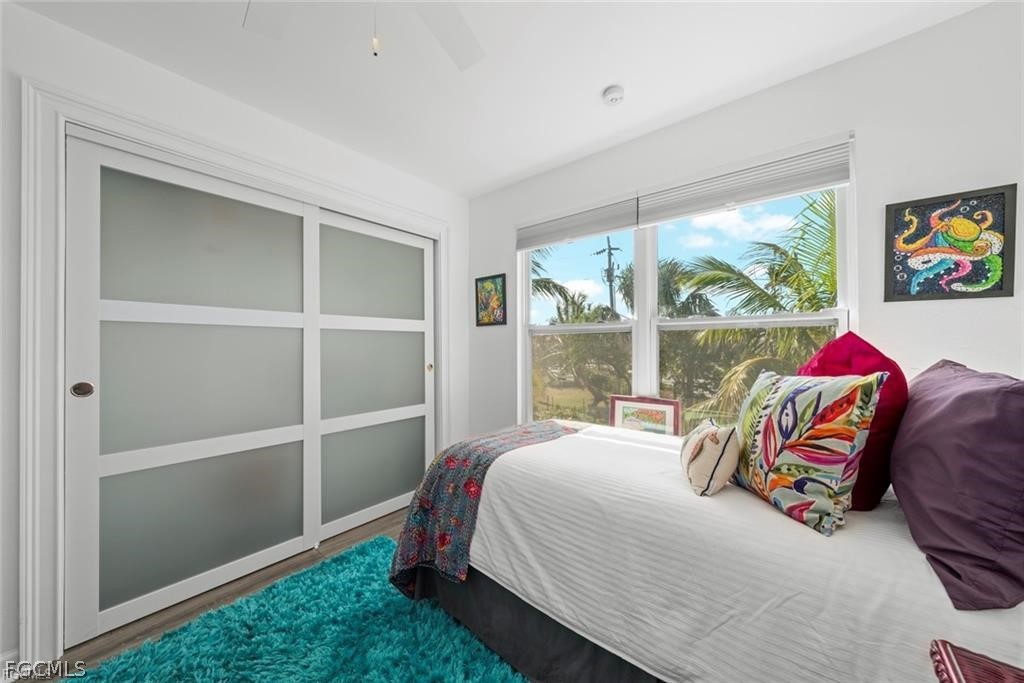 6093 Henderson Road Sanibel, FL 33957 - Photo 30 of 49 a bedroom with a bed and a window