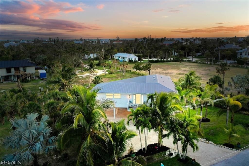 6093 Henderson Road Sanibel, FL 33957 - Photo 34 of 49 a view of a lake with houses in the back