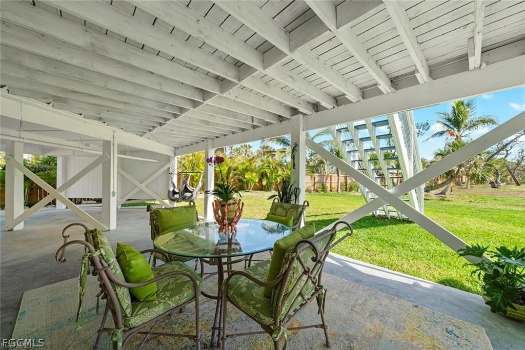 6093 Henderson Road Sanibel, FL 33957 - Photo 42 of 49 a outdoor dining area with furniture and outdoor view