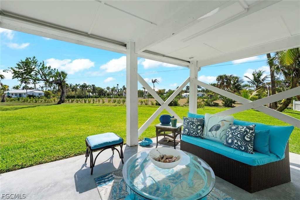 6093 Henderson Road Sanibel, FL 33957 - Photo 44 of 49 a living room with furniture and a garden