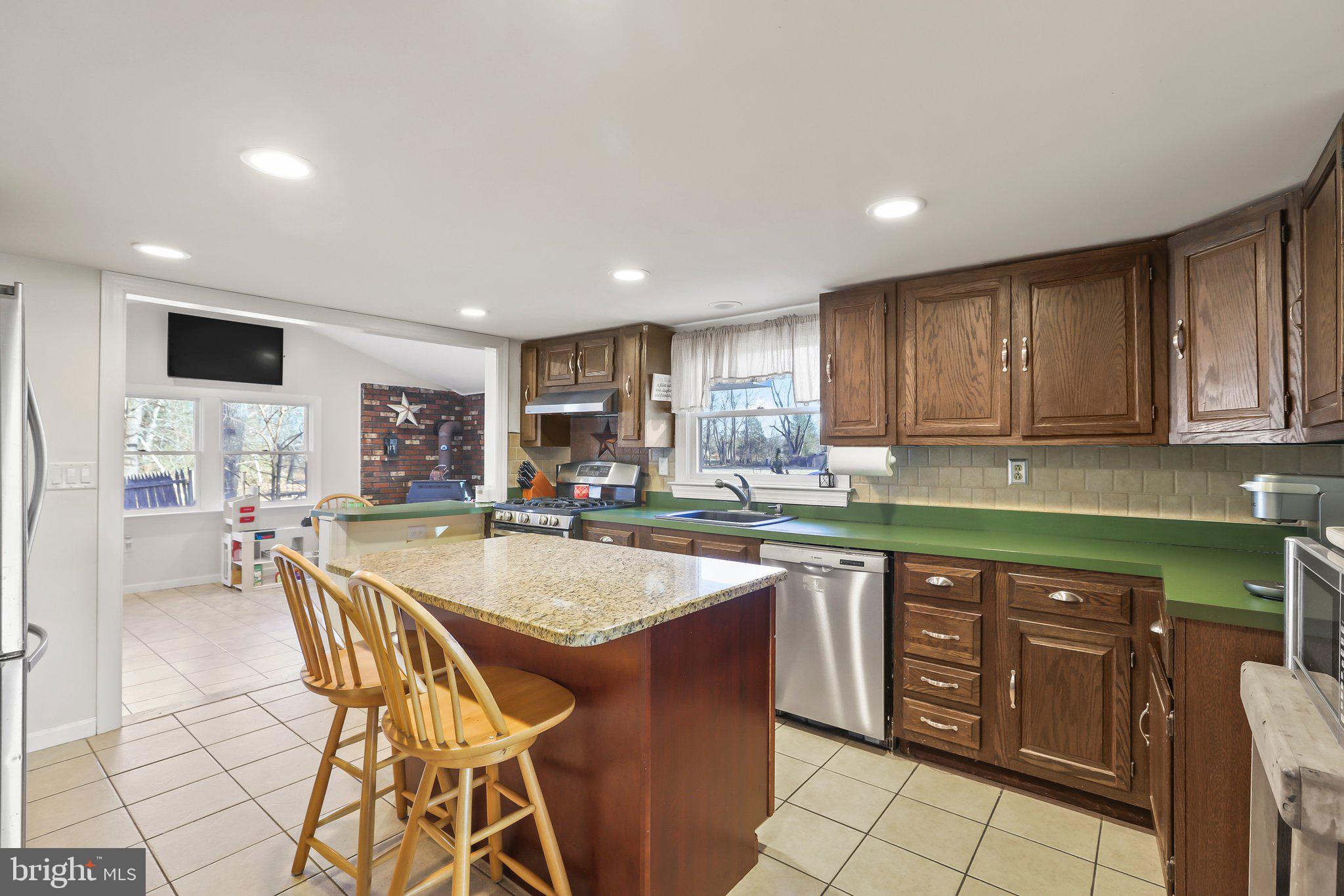 592 Chatsworth Road Tabernacle, NJ 08088 - Photo 13 of 32 a kitchen with stainless steel appliances granite countertop a sink and a refrigerator