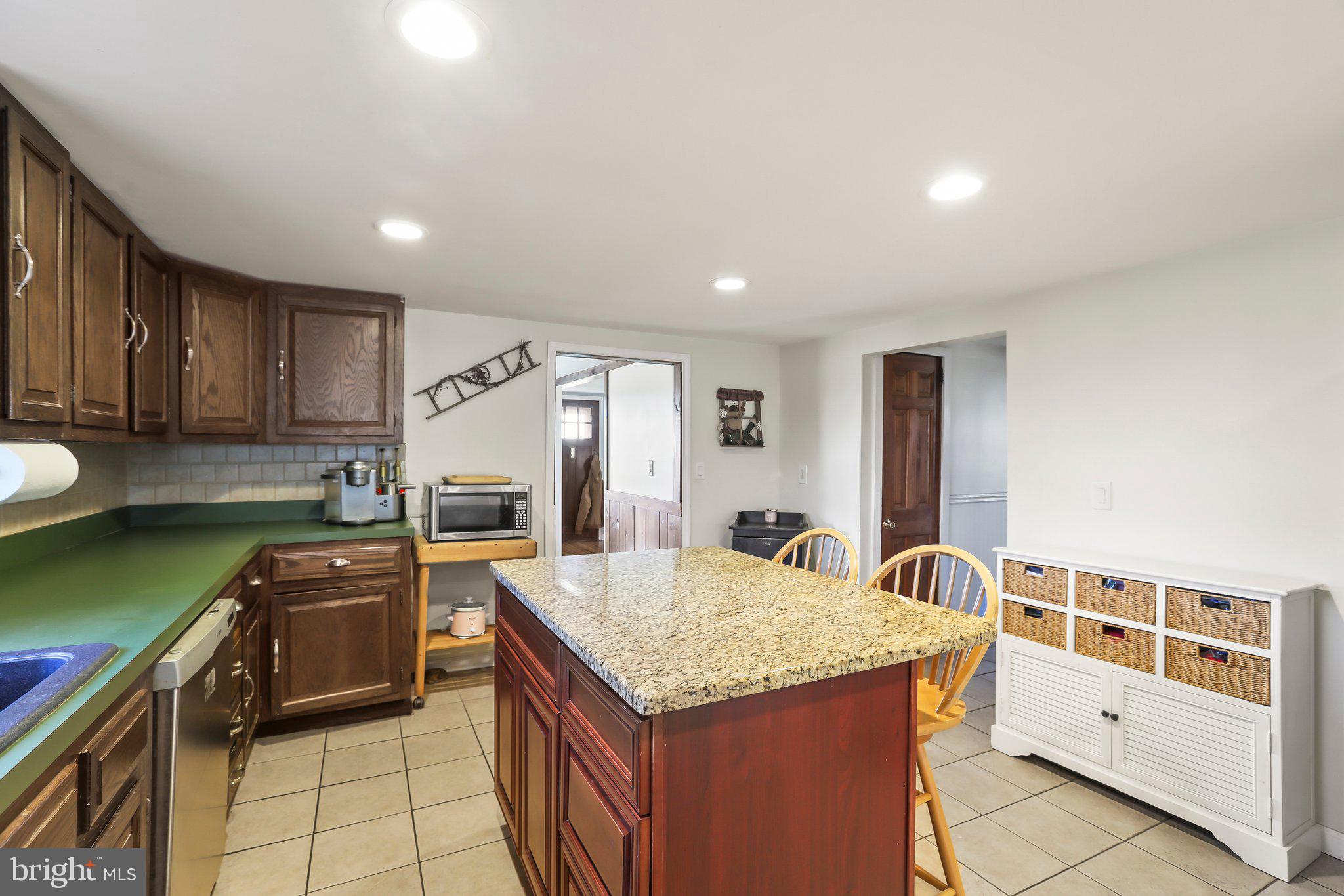 592 Chatsworth Road Tabernacle, NJ 08088 - Photo 16 of 32 a kitchen that has a kitchen island wooden cabinets and stainless steel appliances