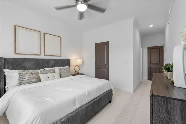 a bedroom with a large bed and a chandelier