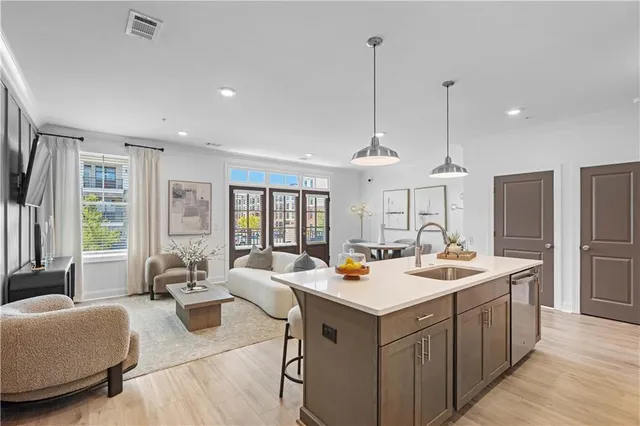 a open kitchen with stainless steel appliances granite countertop a sink counter space and a wooden floor