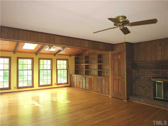 5014 Tremont Drive Raleigh, NC 27609 - Photo 12 of 25 The Family Rm is completely open to the Sun Rm w/vaulted wood ceiling, ceiling beams, 4 skylights, CF, track lighting, built-in cabinets/bookshelves, 5 windows & glass doors to the lg Deck. Sun Room
