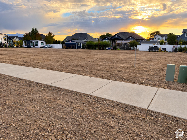 1117 North 600 West, Unit HFE 03 Mapleton, UT 84664 - Photo 2 of 3 Expansive undeveloped lot with a level grade, concrete sidewalk, and utility boxes