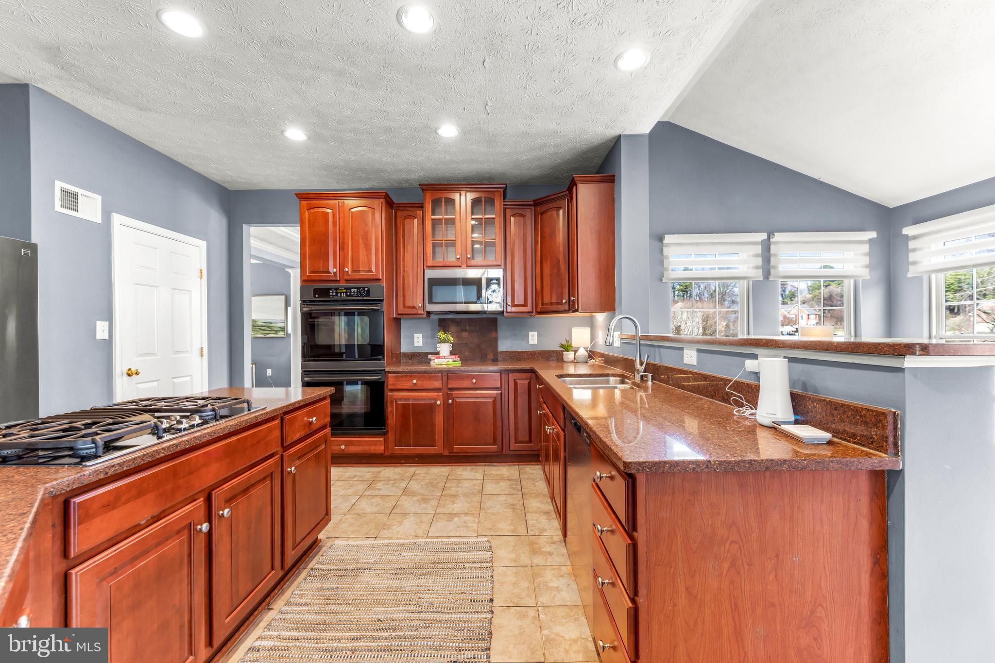 1717 Maco Drive Hanover, MD 21076 - Photo 15 of 93 a kitchen with stainless steel appliances granite countertop sink stove and window
