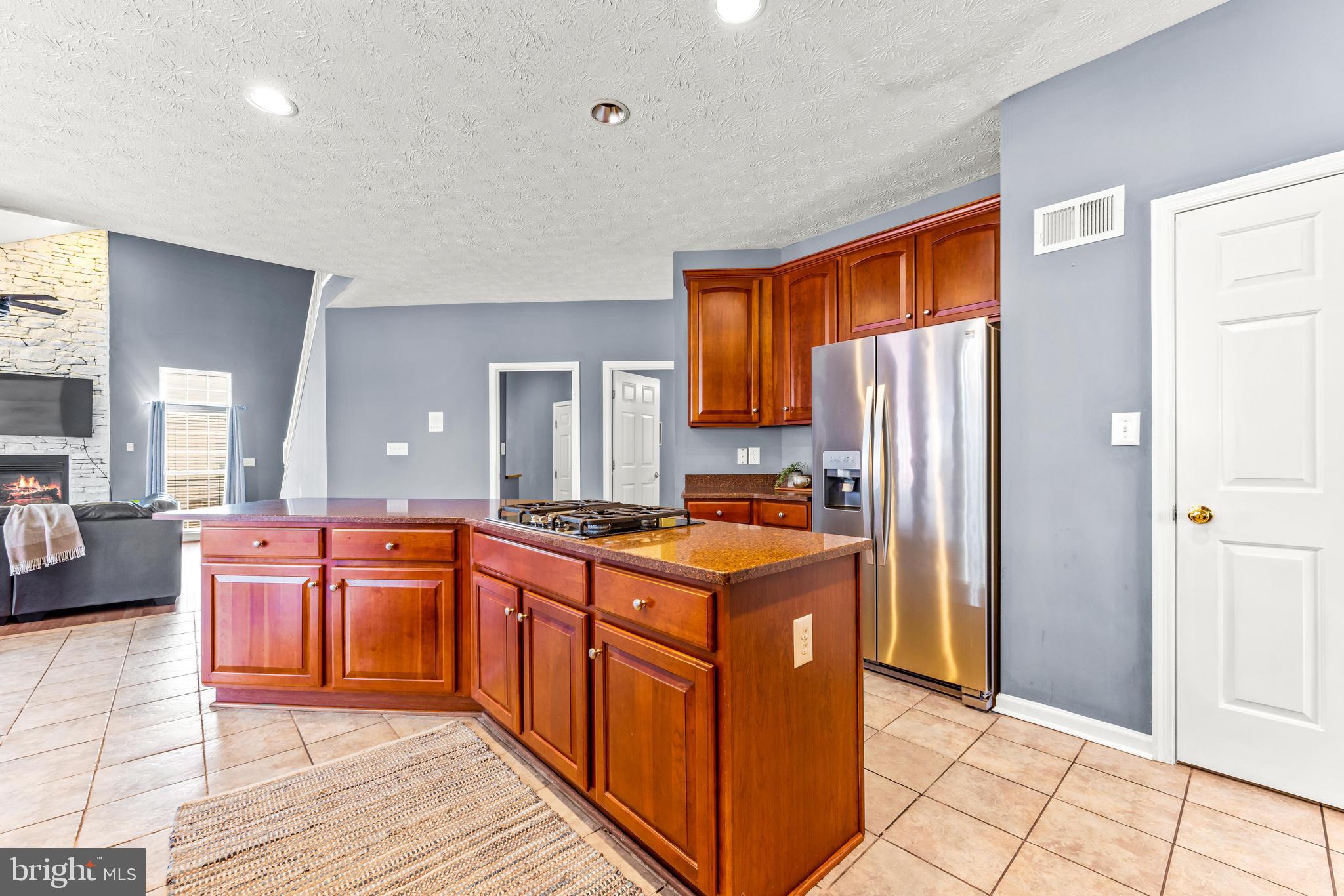 1717 Maco Drive Hanover, MD 21076 - Photo 17 of 93 a kitchen with stainless steel appliances granite countertop a stove top oven a refrigerator a sink and dishwasher with a dining table