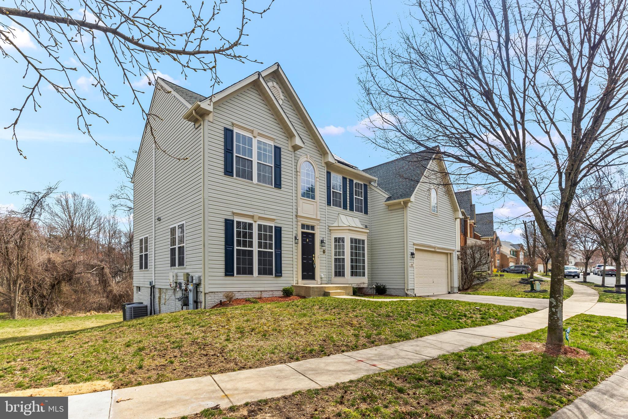 1717 Maco Drive Hanover, MD 21076 - Photo 2 of 93 a view of a large white house with a yard and large tree