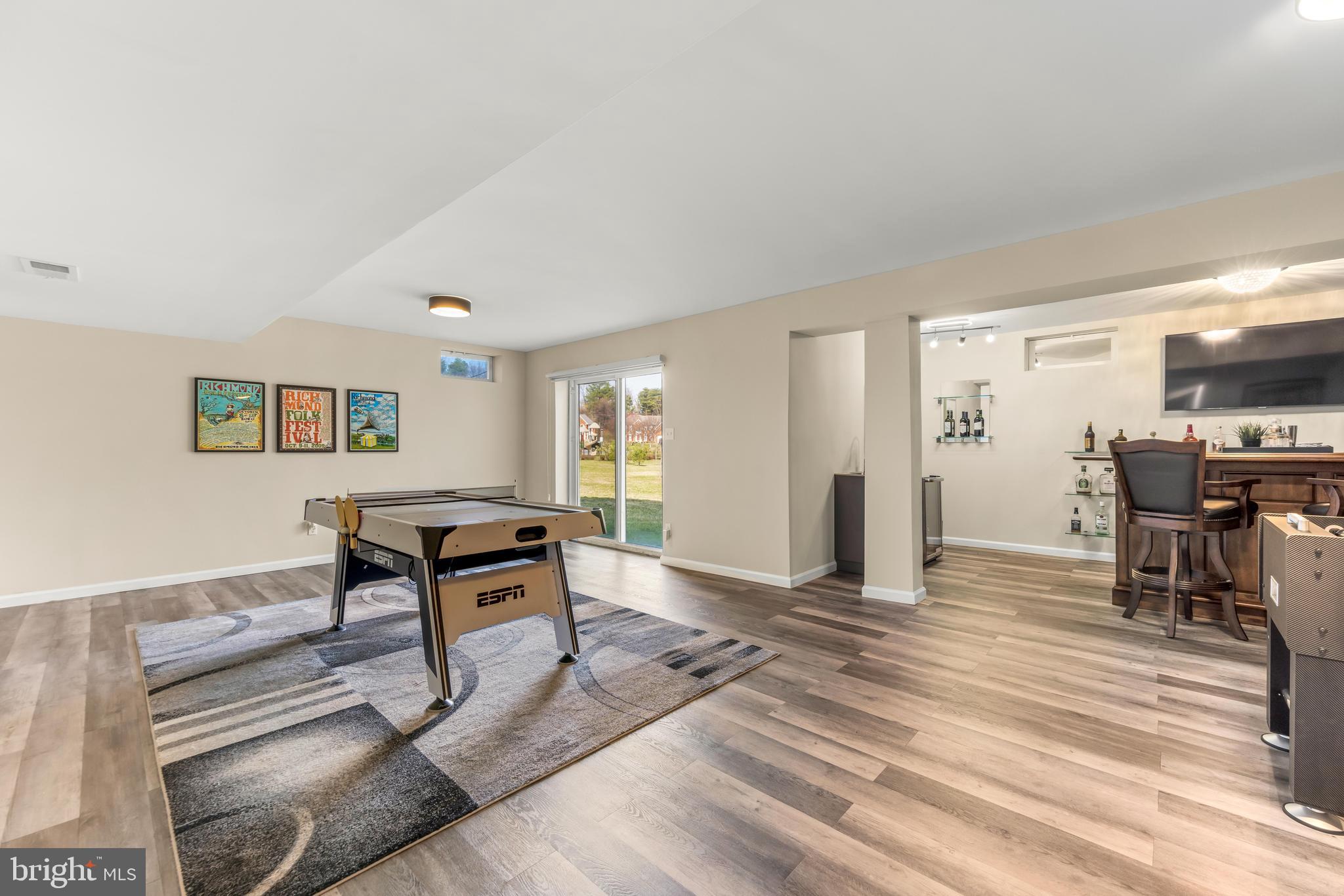 1717 Maco Drive Hanover, MD 21076 - Photo 65 of 93 a living room with furniture a dining table and a wooden floor