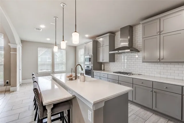 a kitchen with a table chairs sink and cabinets