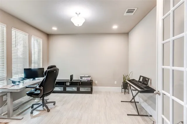 a view of a workspace with furniture and a window