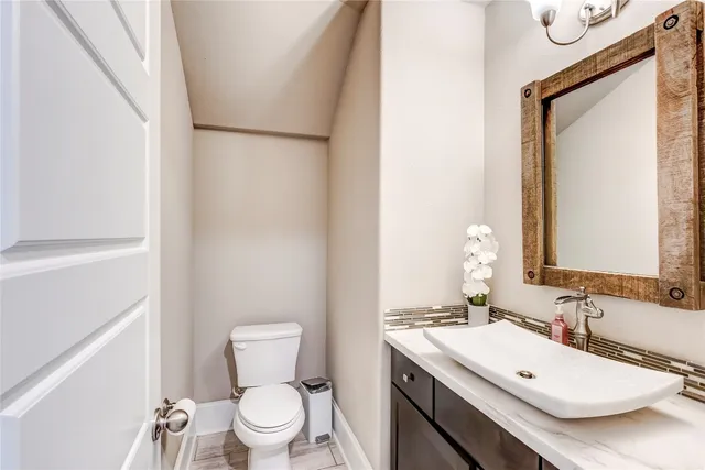 a bathroom with a toilet a sink and a mirror