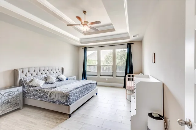 a living room with a bed furniture and a large window