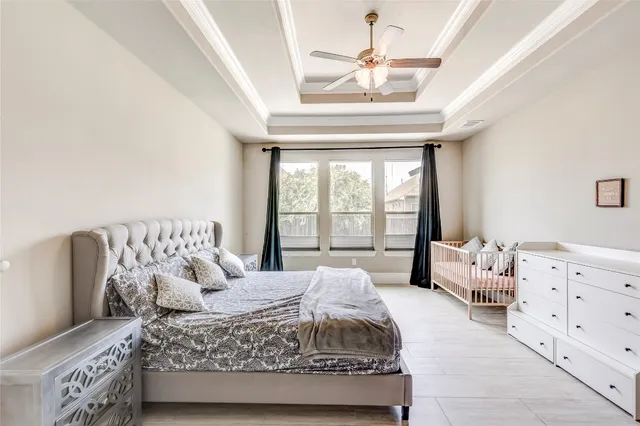 a bedroom with a bed and ceiling fan