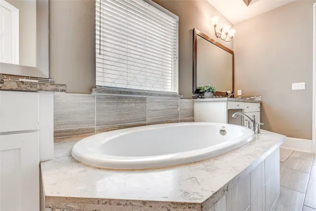 a bath tub sitting in a bathroom next to a sink