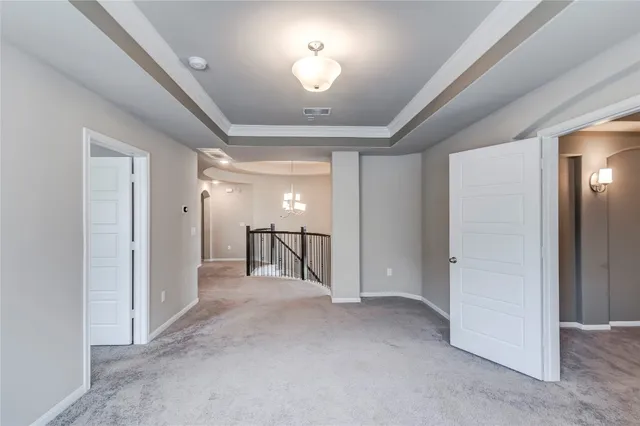 en empty room with closet and chandelier fan